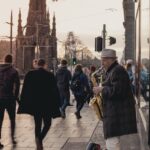 street musician playing saxophone outside a busy area in edinburgh